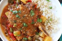 Slow Cooker Sazon Pork Chops with Peppers, Olives and Potatoes