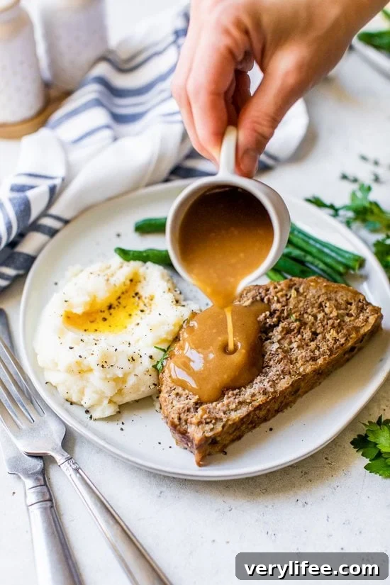 Meatloaf and Gravy with mashed potatoes and green beans.