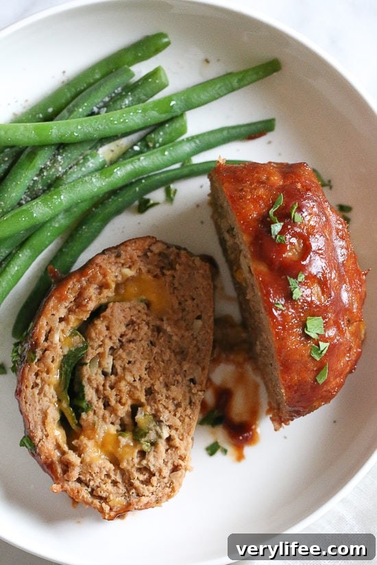 Cheese stuffed turkey meatloaf rolled with spinach and cheddar.