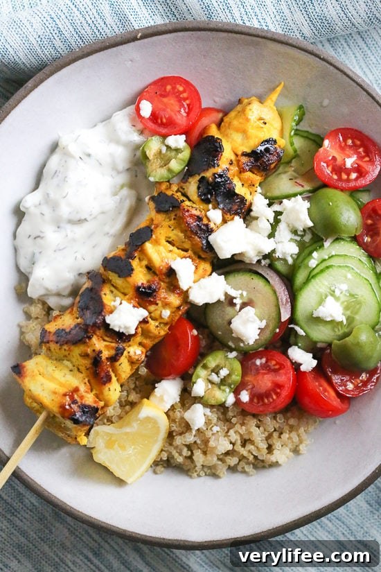 Yogurt-marinated grilled chicken served over quinoa with tzatziki