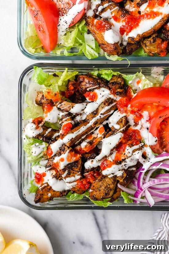 Halal food cart-style chicken served over salad with white sauce