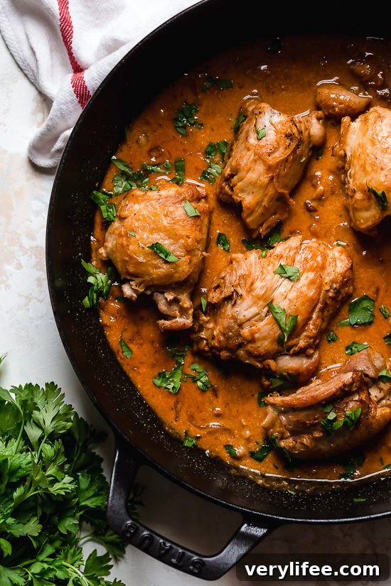 Chicken thighs in a skillet with shallots and wine sauce