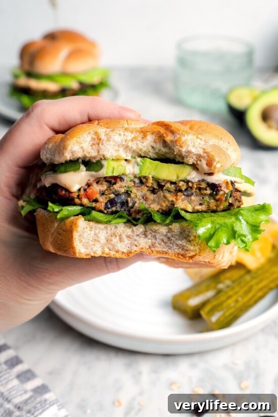 Hand holding veggie burger with bite taken out