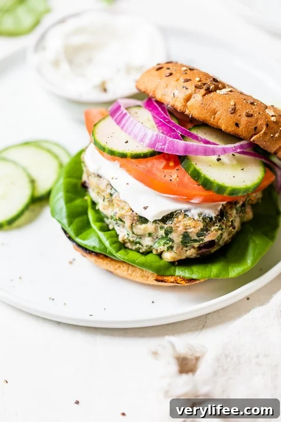 Greek turkey burger with bun, tomatoes, cucumber on a plate