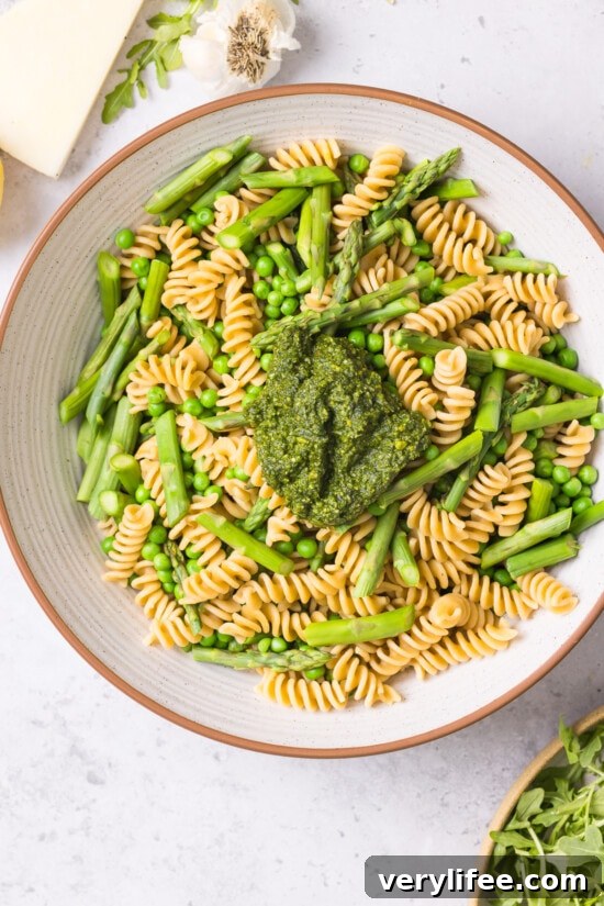 Spring Pesto Pasta with Asparagus, Peas, Arugula and Pistachios 5 pasta and vegetables in a bowl