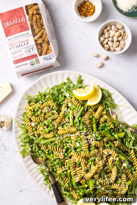 Spring Pesto Pasta with Asparagus, Peas, Arugula and Pistachios 6 pasta with arugula, peas and asparagus on a platter