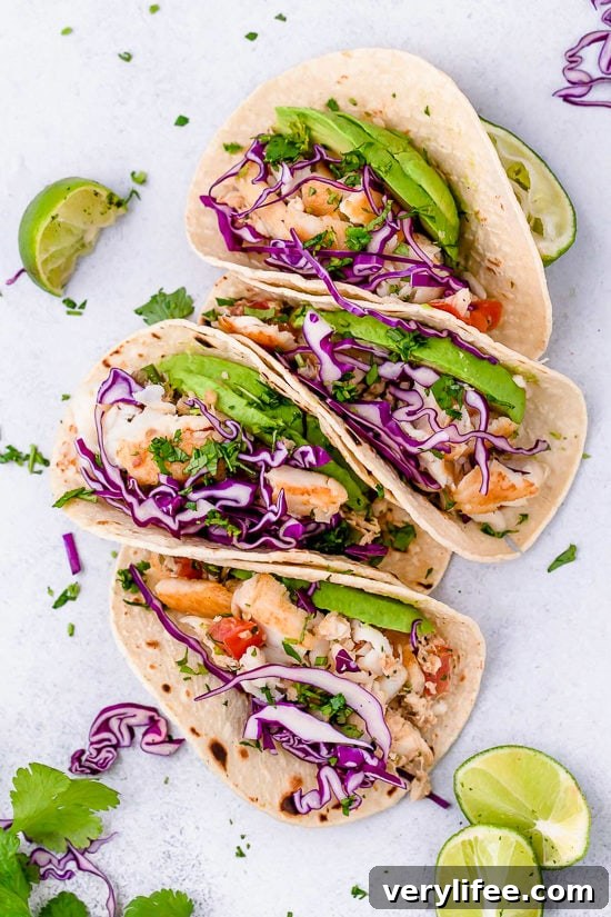 These easy Cilantro Lime Fish Tacos are made with flaky white fish, tomatoes, jalapeños, cilantro and lime topped with avocado.