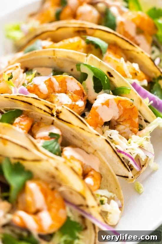 Spicy shrimp tacos topped with cabbage slaw and spicy cream sauce