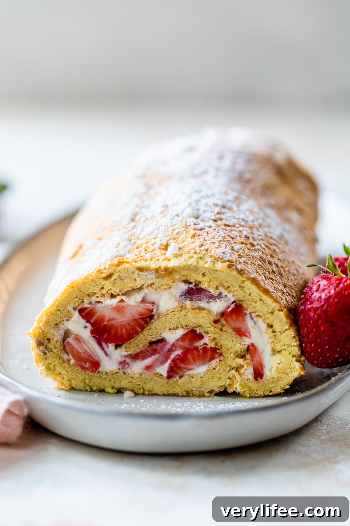 Strawberry Swiss Roll Recipe 2 Strawberry Swiss Roll on a plate