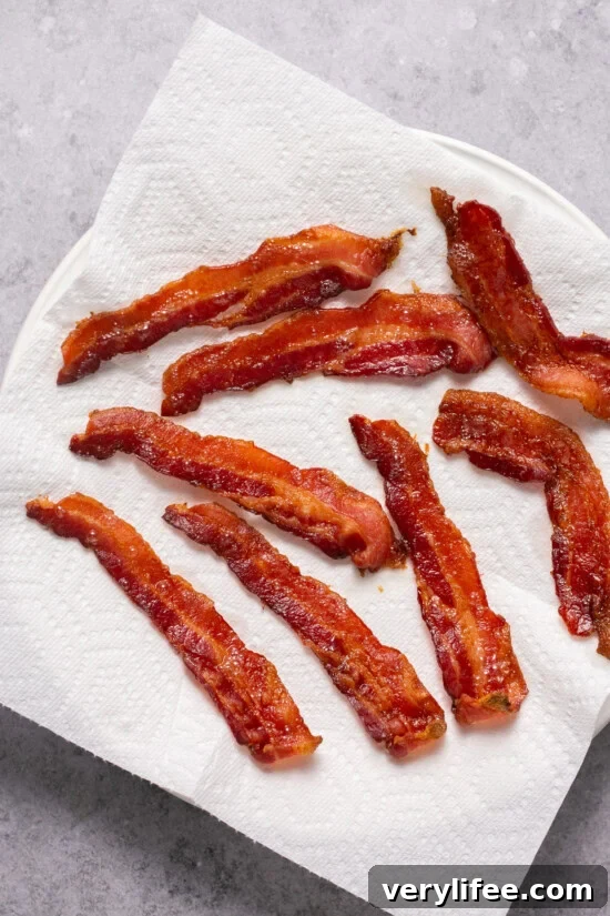 Place cooked bacon on a paper towel-lined plate bacon on a paper towel-lined plate