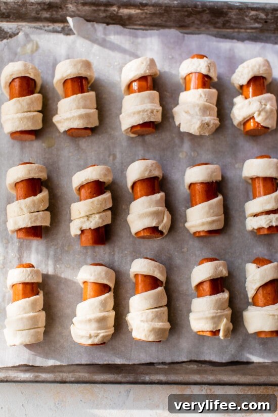 Mummy Hot Dogs: Halloween Party Recipe 6 hot dogs wrapped in dough