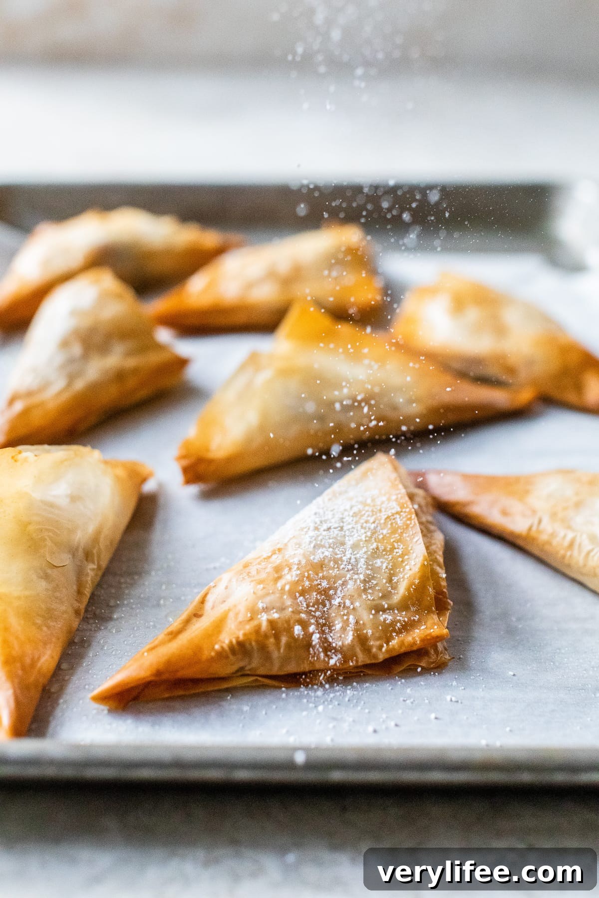 Flaky Apple Turnovers with Cinnamon Sugar Glaze 3 Apple Turnovers with powdered sugar.