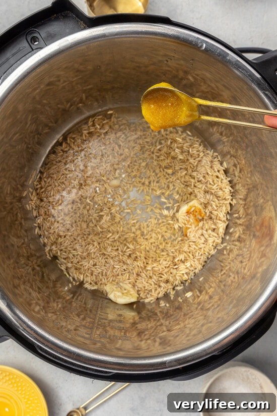 Instant Pot Brown Rice: Perfectly Fluffy Every Time 3 adding bouillon to the pot
