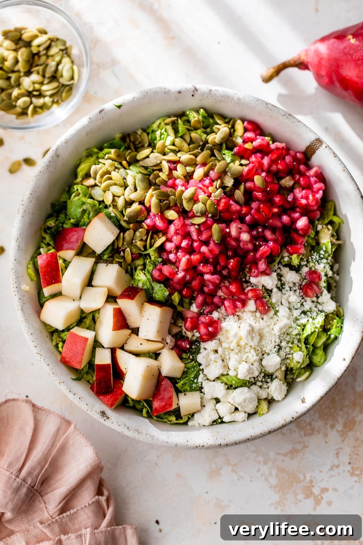 Shaved Brussels Sprouts Salad with Pears, Pomegranate and Pepitas