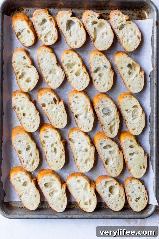 Creamy Spinach and Artichoke Crostini 6 sliced bread on a sheet pan