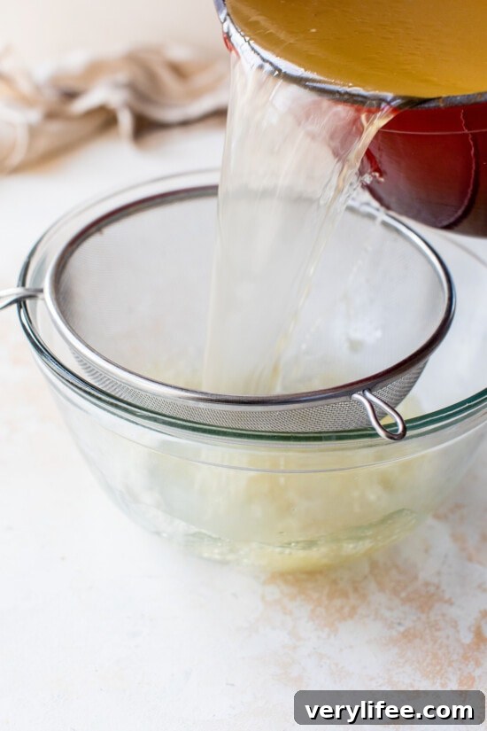 Draining Turkey Stock through a mesh sieve