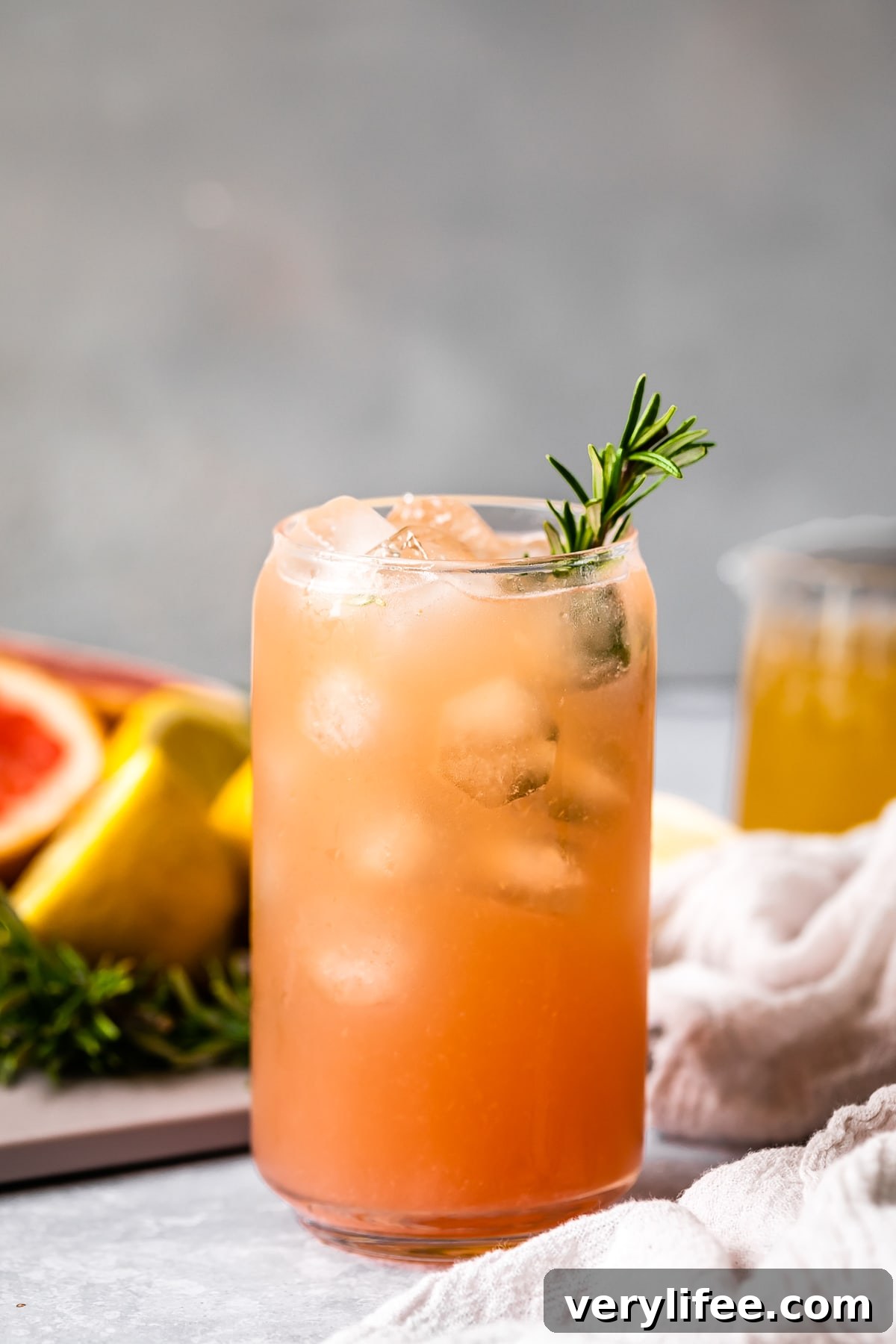 Grapefruit Ginger Kombucha Mocktail Recipe 5 grapefruit mocktail with rosemary sprig in a glass