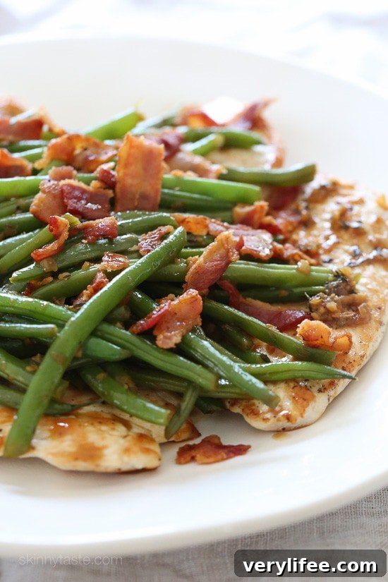 One skillet chicken with bacon and green beans in a white wine sauce.