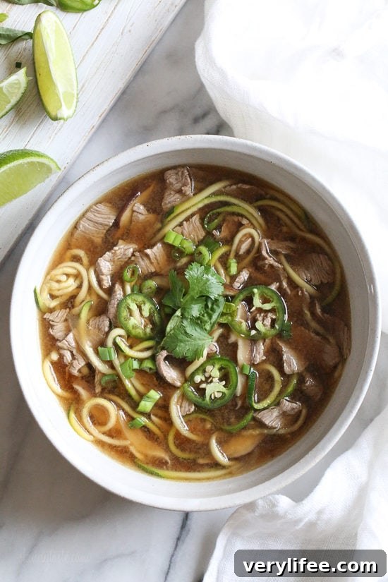 Asian beef zoodle soup substitutes zucchini noodles for rice noodles in a fragrant broth.