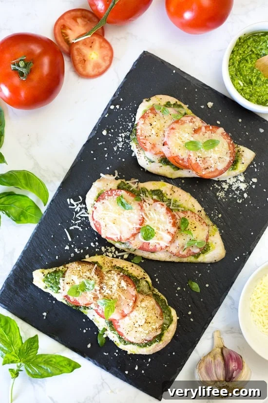 Baked pesto chicken with tomatoes, mozzarella and Parmesan.