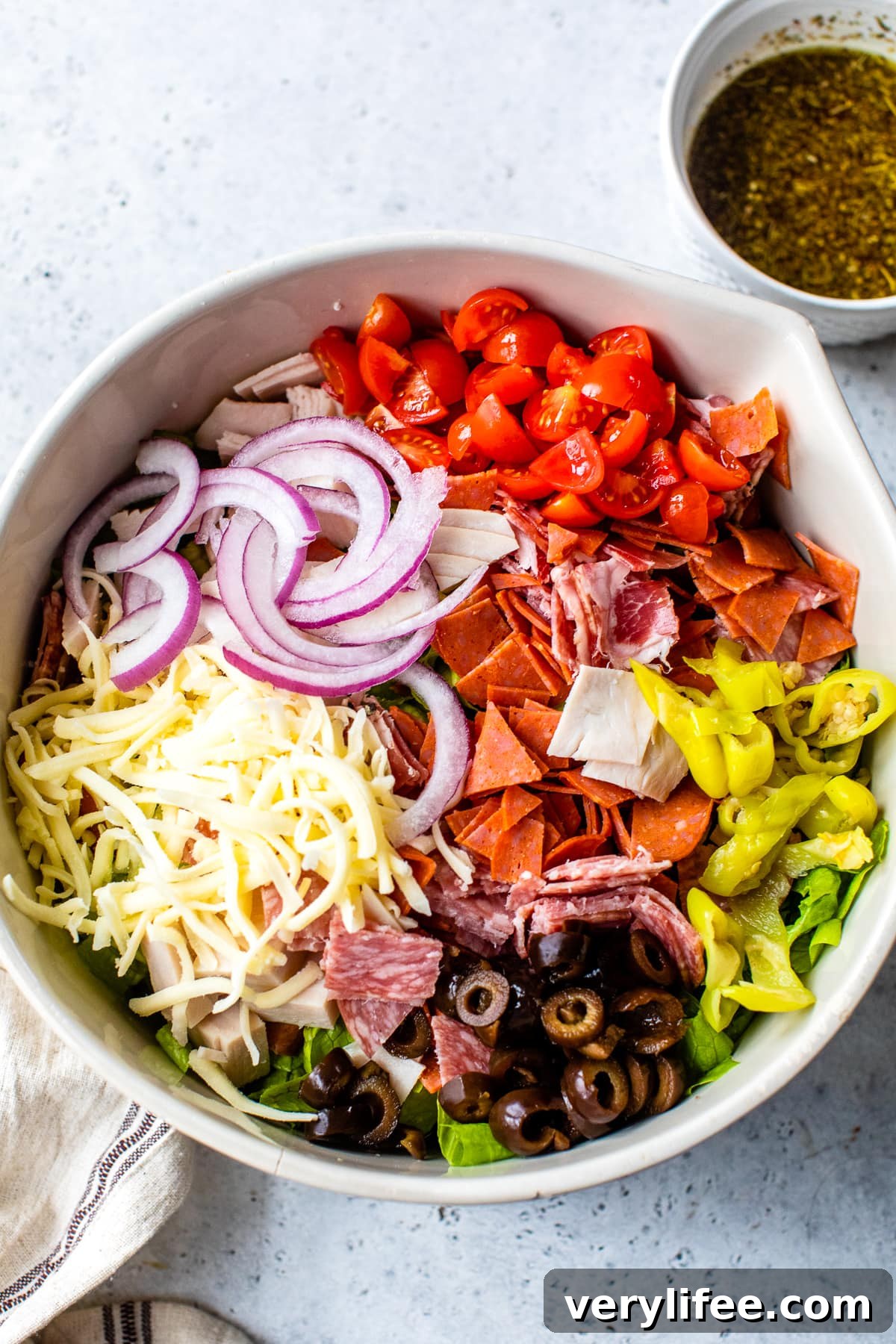 Italian Sub Salad with Salami, Provolone & Pepperoncini 3 tomatoes, red onions, cheese, olives, salami, lettuce, banana peppers