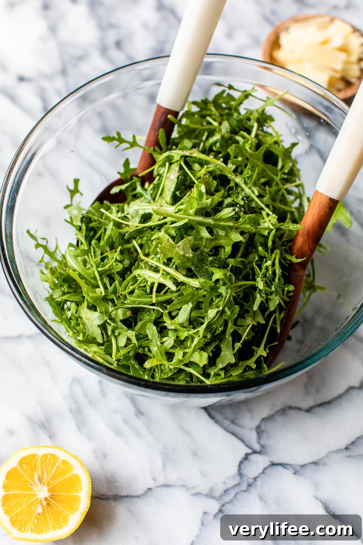 Arugula Salad with Lemon Vinaigrette and Parmesan 4 tossing arugula in a bowl