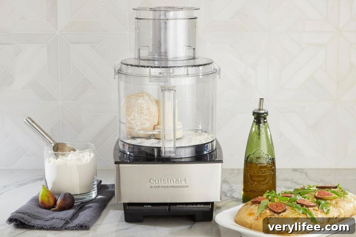 Cuisinart food processor on counter next to bread