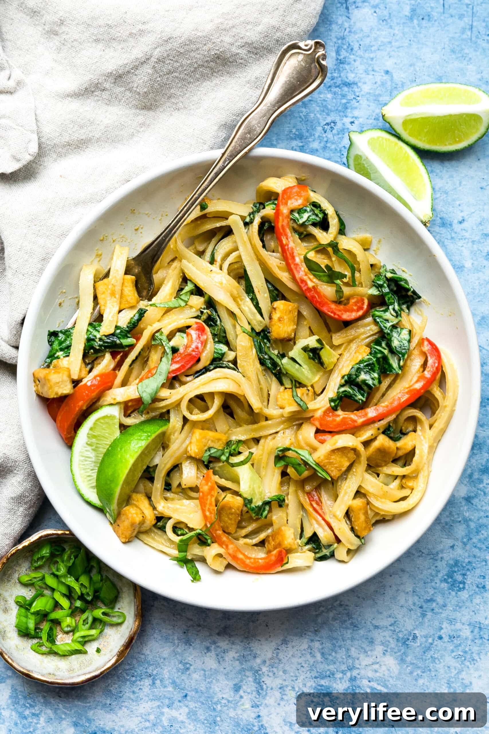 Green Curry Noodles in a bowl with limes.