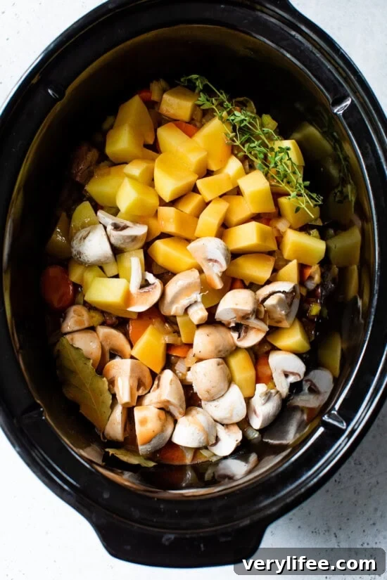 crock pot with beef potatoes and veggies