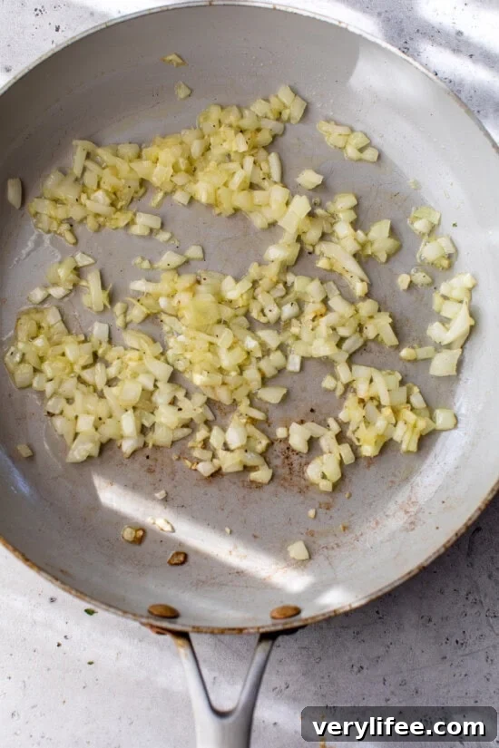 Classic French Ratatouille Recipe 5 Onions cooking in a skillet.