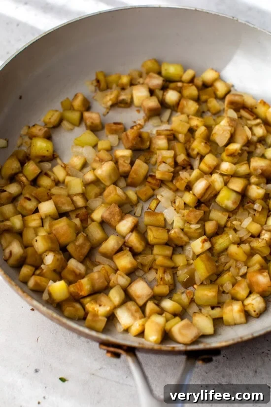Classic French Ratatouille Recipe 6 Eggplant cooking in a skillet.