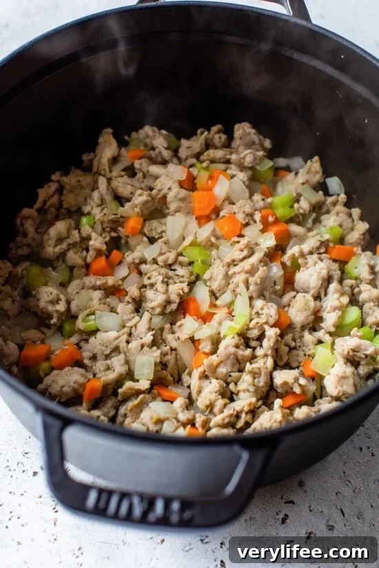 Sauté the vegetables and sausage