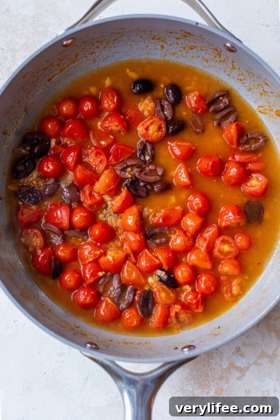Tomatoes and olives in a skillet