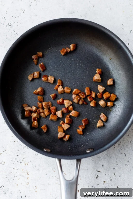 Breakfast Quesadilla Recipe with Eggs, Cheese and Crispy Bacon 7 sausage in skillet