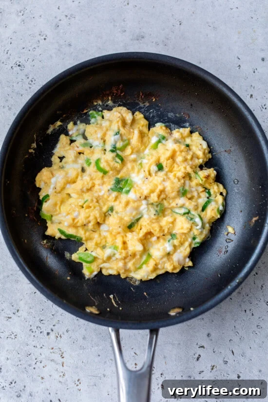 Breakfast Quesadilla Recipe with Eggs, Cheese and Crispy Bacon 9 eggs in skillet