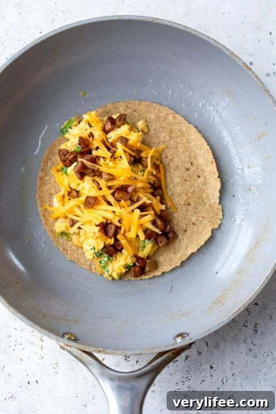 Breakfast Quesadilla Recipe with Eggs, Cheese and Crispy Bacon 10 Breakfast Quesadilla in skillet