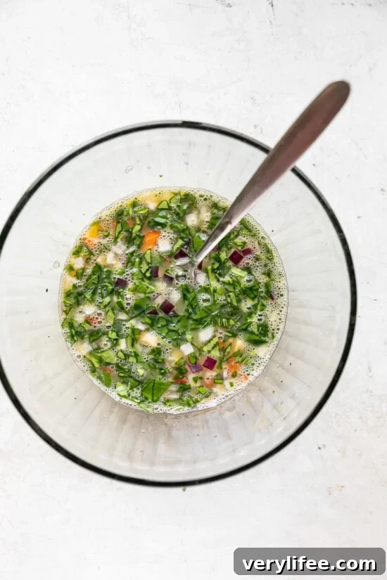 Beat eggs and egg whites and add veggies.