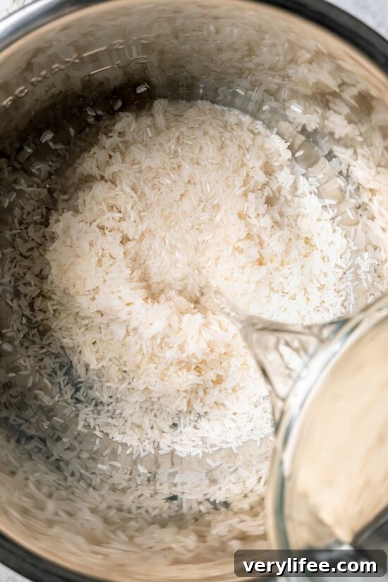 Pouring water into instant pot with rice
