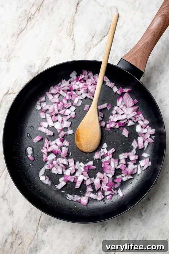 Vegan Lentil Tacos with Spiced Tomato Salsa 6 Red onions cooking in skillet