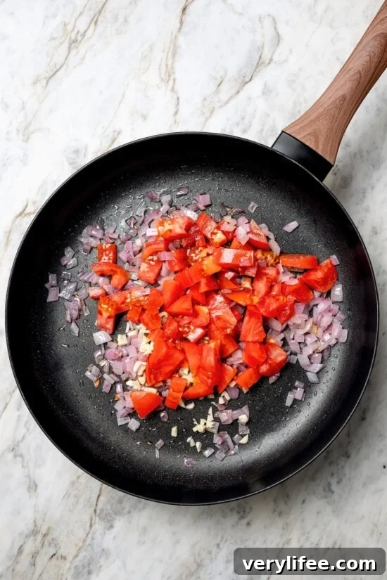 Vegan Lentil Tacos with Spiced Tomato Salsa 7 Tomatoes added to skillet of red onions