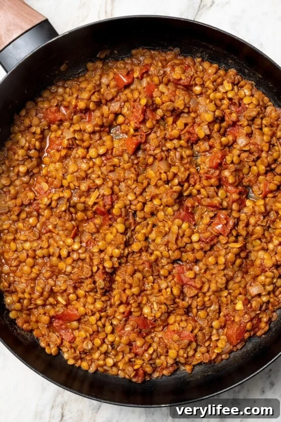 Vegan Lentil Tacos with Spiced Tomato Salsa 9 Overhead view of lentils cooked in skillet