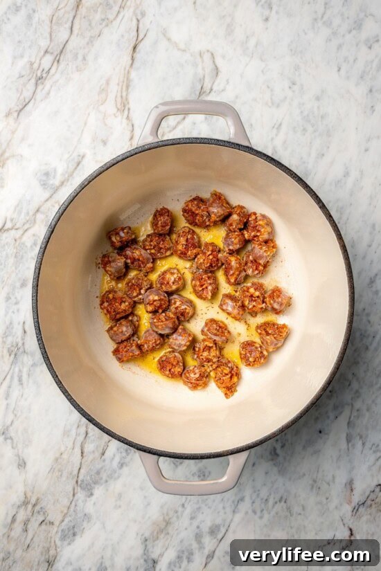 Overhead view of chorizo cooking in Dutch oven