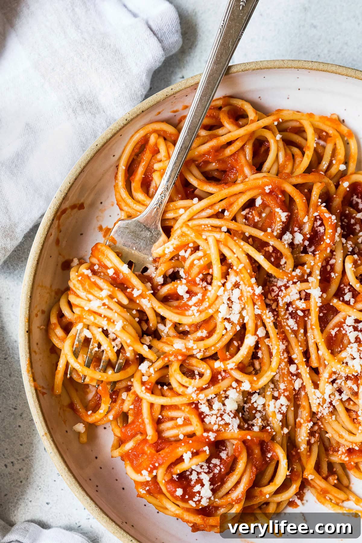 Pasta tossed with light tomato sauce and sprinkled with Parmesan cheese