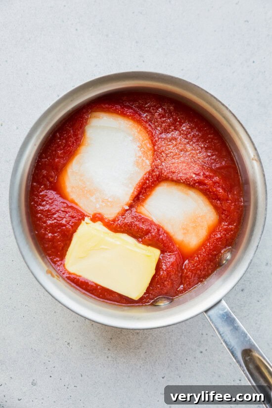 onion, butter and crushed tomatoes in a pot