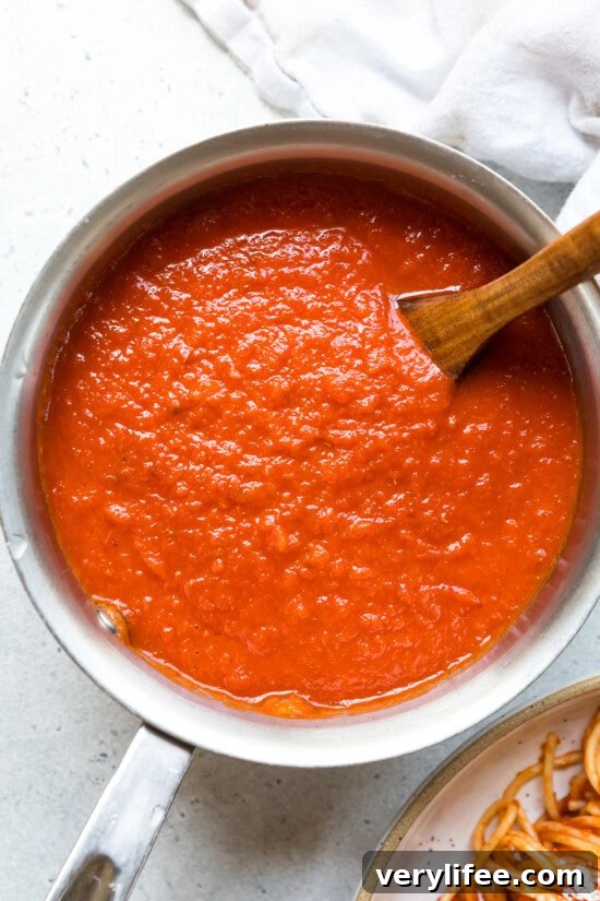 Close-up of rich, smooth tomato sauce showing velvety consistency