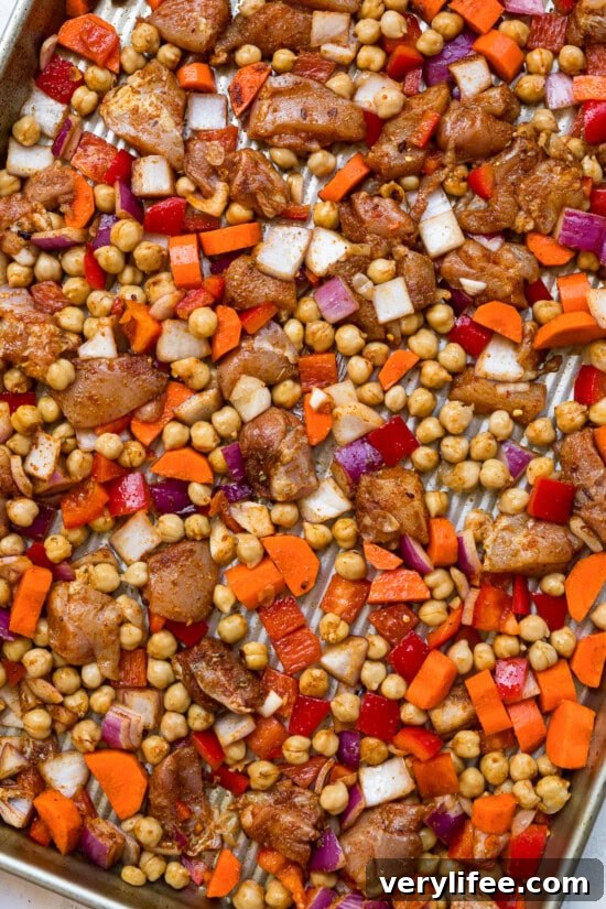 Chicken, vegetables and chickpeas on a baking sheet