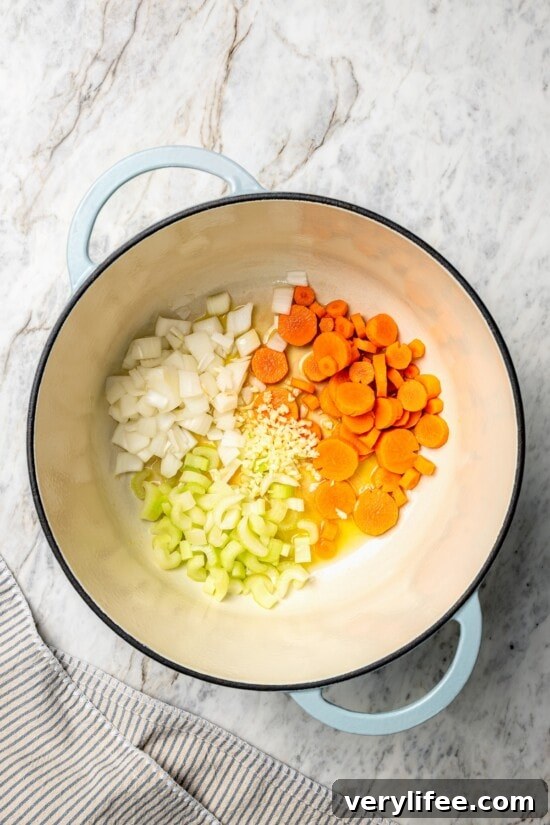 Creamy Chicken and Corn Chowder Recipe 5 Carrots, celery, onion, and garlic in dutch oven.
