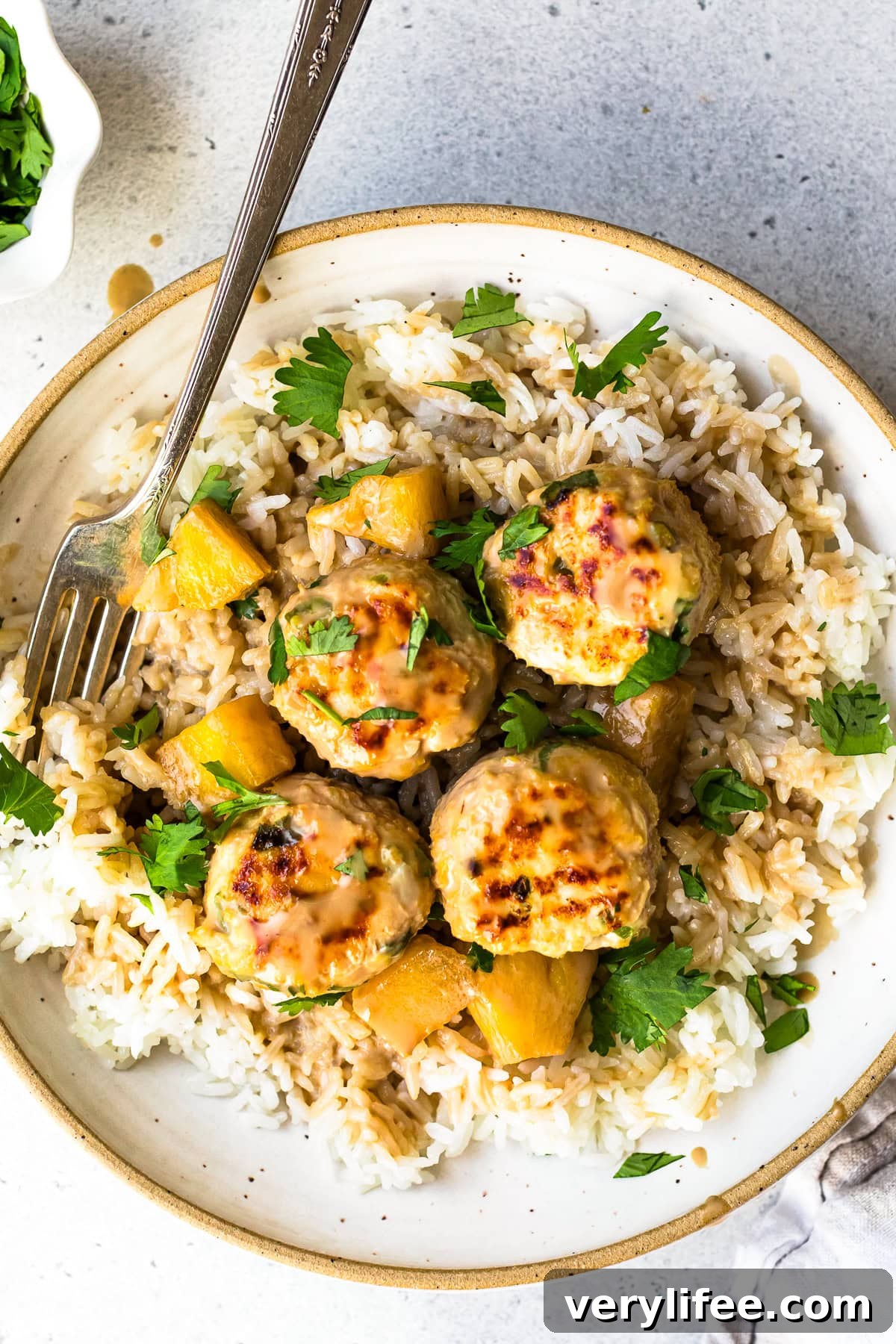 Pineapple-Glazed Hawaiian Chicken Meatballs 2 Hawaiian Chicken Meatballs with Pineapple Coconut Sauce over rice