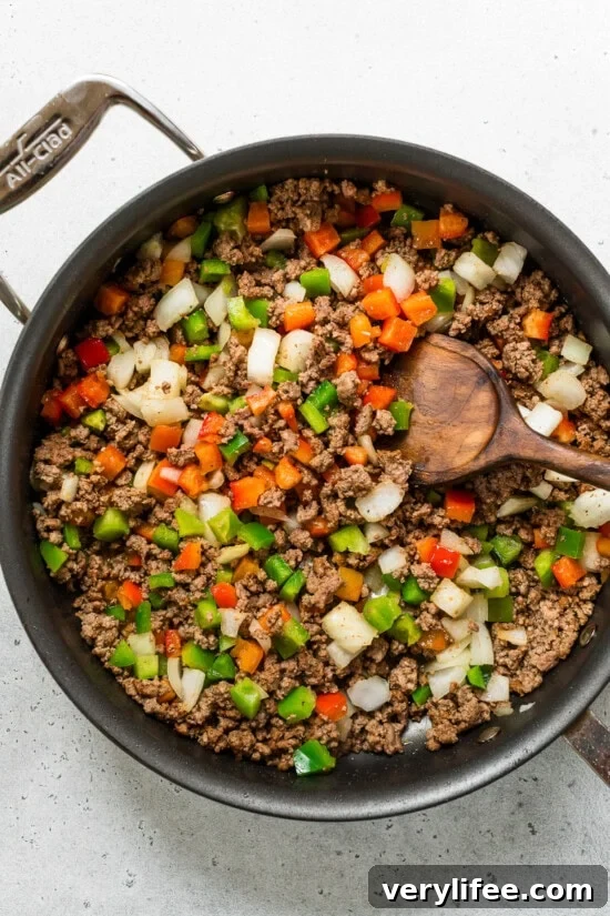ground beef peppers and onions in a skillet