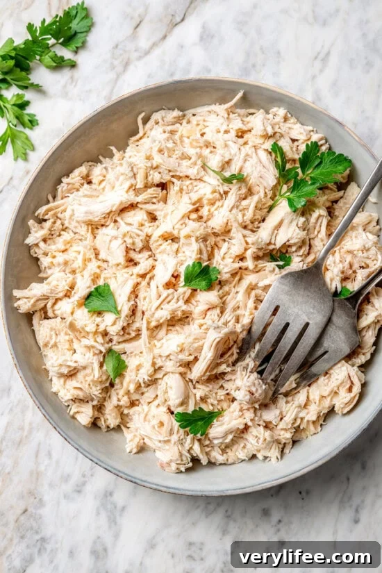 25 Crockpot Dinner Recipes to Enjoy Year-Round 8 Bowl of crockpot shredded chicken with 2 forks